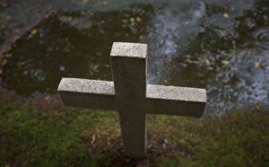 Images Dated 19th August 2014: A cross mark the grave of a soldier in one of the WW1 military cemeteries in the village