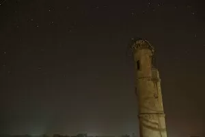 Images Dated 12th December 2015: A damaged minaret is pictured at night in Aleppo, Syria