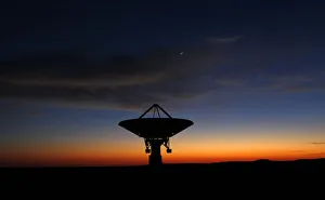 Dawn breaks over a radio telescope dish of the KAT-7 Array pointing skyward at the Dawn breaks over a radio telescope dish of the KAT-7 Array pointing skyward at the