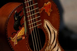 A decorated Spanish guitar is seen as folk music guitarists perform during the