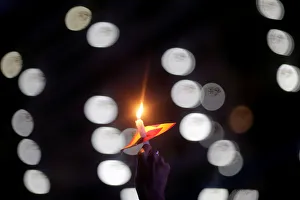 A demonstrator holds a candle as she takes part in a rally against the shooting of Rio de A demonstrator holds a candle as she takes part in a rally against the shooting of Rio de