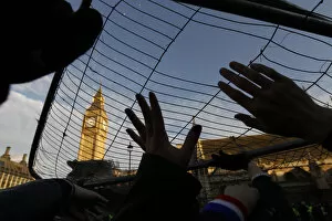 Images Dated 9th December 2010: Demonstrators hold barriers above their heads in Parliament Square in central London