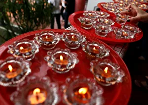 A devotee offers candles ahead of Vesak Day at Kong Meng San Phor Kark See Monastery in A devotee offers candles ahead of Vesak Day at Kong Meng San Phor Kark See Monastery in