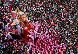 Devotees carry an idol of Hindu god Ganesh during a procession on the last day of Devotees carry an idol of Hindu god Ganesh during a procession on the last day of
