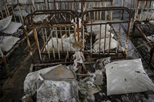 A doll is seen amongst beds at a kindergarten in the abandoned city of Pripyat near the