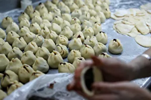 An employee makes mooncakes with anti-extradition bill slogans at Wah Yee Tang Bakery in An employee makes mooncakes with anti-extradition bill slogans at Wah Yee Tang Bakery in