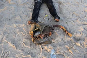 The feet and utility belt of what Ivorian security officers said was a dead attacker is The feet and utility belt of what Ivorian security officers said was a dead attacker is