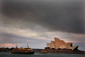 Ferries sail past the Sydney Opera House as smoke from bushfires can be seen above Ferries sail past the Sydney Opera House as smoke from bushfires can be seen above