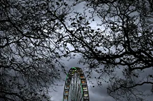 A ferris wheel is illuminated against the evening sky in Hyde Park in London, Britain A ferris wheel is illuminated against the evening sky in Hyde Park in London, Britain