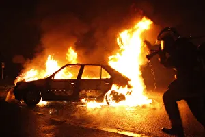 A firefighter extinguishes a burning car early this morning during the New Years eve A firefighter extinguishes a burning car early this morning during the New Years eve