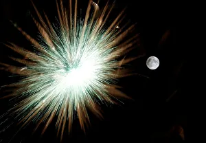 Fireworks explode in front of the full moon during celebrations marking the feast Fireworks explode in front of the full moon during celebrations marking the feast