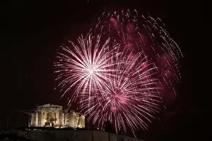 Images Dated 31st December 2012: Fireworks explode over the temple of the Parthenon during New Year celebrations in Athens