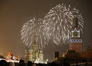 Images Dated 31st December 2014: Fireworks light the sky over St. Basils Cathedral and Kremlins Spasskaya Tower