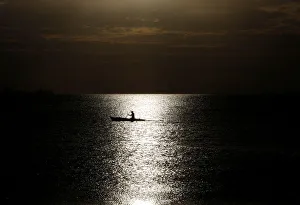 A fisherman casts his net before sunset in Baseco district, metro Manila A fisherman casts his net before sunset in Baseco district, metro Manila