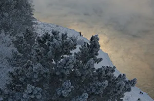 A fisherman is seen on a bank of the Yenisei River at sunset near the Krasnoyarsk hydro A fisherman is seen on a bank of the Yenisei River at sunset near the Krasnoyarsk hydro