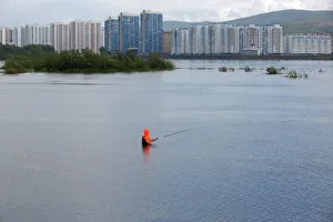 A fisherman stands in the waters of the Yenisei River in the Siberian city of Krasnoyarsk A fisherman stands in the waters of the Yenisei River in the Siberian city of Krasnoyarsk