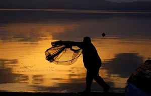 New Gallery: A fisherman uses his net at Lake Ohrid in Ohrid