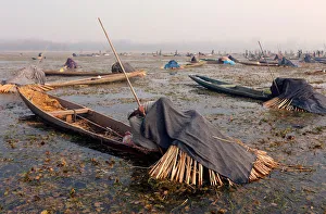 Fishermen cover their heads and part of their boats with blankets Fishermen cover their heads and part of their boats with blankets