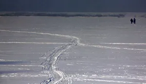 Two fishermen walk on the the frozen Songhua River in the northern city of Harbin Two fishermen walk on the the frozen Songhua River in the northern city of Harbin