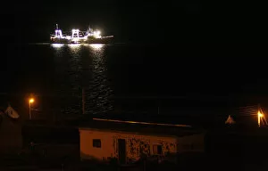 Images Dated 13th March 2012: A fishing ship is seen at night along the coast of Port Stanley