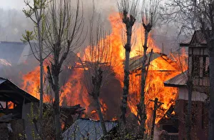Flames and smoke billow from residential houses after they caught fire during a gunbattle Flames and smoke billow from residential houses after they caught fire during a gunbattle