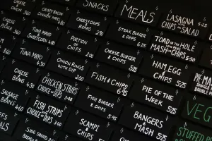 Prints of The menu board is seen inside the Little Driver pub in east London January 26, 2012 Sport Prints: Print of a traditional east London pub menu board