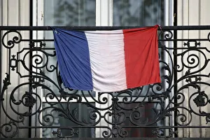 A French flag hangs from a balcony in Paris to pay tribute to the victims of the Paris A French flag hangs from a balcony in Paris to pay tribute to the victims of the Paris