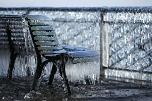 Seasons Gallery: A frozen public bench is seen next to a lake side due to the heavy wind conditions