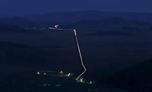 A general view from the slope of the Sayan mountains shows a highway at an administrative A general view from the slope of the Sayan mountains shows a highway at an administrative