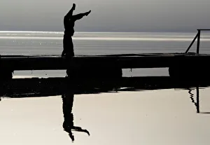 A girl practices yoga on the banks of Lake Ohrid in Ohrid A girl practices yoga on the banks of Lake Ohrid in Ohrid