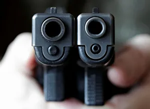 Ominous Gallery: A gun owner displays a Glock 20, 10 mm Auto next to a Glock 19