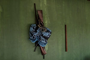 Images Dated 23rd September 2019: Guns hang with a hammock on the wall of a Tembe indigenous tribes house
