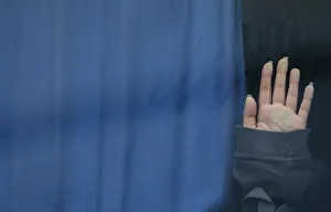 A hand of a migrant touches a bus window at the Croatia-Slovenia border crossing at A hand of a migrant touches a bus window at the Croatia-Slovenia border crossing at