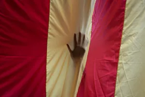 A hand is seen through a giant Estelada (Catalan separatist flag A hand is seen through a giant Estelada (Catalan separatist flag