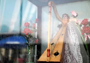 A harp that is held by an image of Saint Cecilia, patron of musicians A harp that is held by an image of Saint Cecilia, patron of musicians