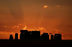 A helicopter flies behind the Stonehenge stone circle during sunset in southwest Britain A helicopter flies behind the Stonehenge stone circle during sunset in southwest Britain
