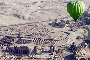 A hot-air balloon flies near Ramesseum temple on the west bank of Luxor A hot-air balloon flies near Ramesseum temple on the west bank of Luxor