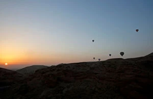 Africa Gallery: Hot-air balloons carrying tourists fly at sunrise over the city of Luxor