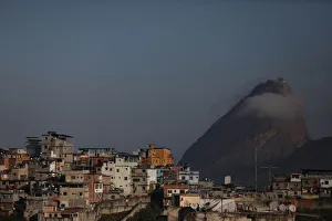 Houses at the Santo Amaro slum are seen with the Sugar Loaf mountain in the background Houses at the Santo Amaro slum are seen with the Sugar Loaf mountain in the background
