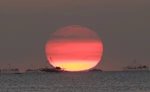 Houses on stilts are seen as the sun sets around the Manila bay in Manila Houses on stilts are seen as the sun sets around the Manila bay in Manila