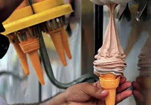 An ice cream vendor fills a cone with chocolate ice cream in Peshawar An ice cream vendor fills a cone with chocolate ice cream in Peshawar