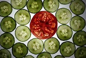 Illustration photo of slices of cucumber and a tomato slice Illustration photo of slices of cucumber and a tomato slice