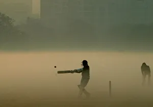 Indian boys play cricket amid thick fog during a chilly morning in Kolkata Indian boys play cricket amid thick fog during a chilly morning in Kolkata