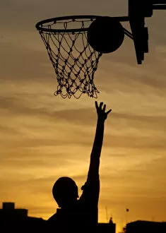 Images Dated 21st February 2006: An Indian girl plays basketball in the evening in Chennai