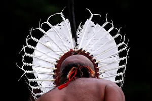 An indigenous man from the Torres Strait Islands wears a traditional dress as he performs An indigenous man from the Torres Strait Islands wears a traditional dress as he performs