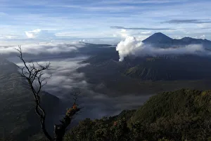 Indonesia Gallery: Indonesias Mount Bromo volcano spew smoke next to Mount Semeru volcano as seen
