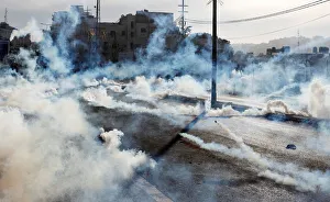 Israeli forces fire gas canisters at Palestinian protesters during a protest in the West Israeli forces fire gas canisters at Palestinian protesters during a protest in the West