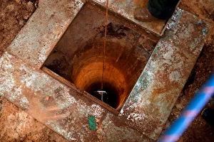 An Israeli soldier lowers a camera down an Israeli-dug hole into a cross-border tunnel An Israeli soldier lowers a camera down an Israeli-dug hole into a cross-border tunnel