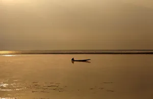 A Kashmiri man catches fish in the waters of Dal Lake on a cold winter morning in A Kashmiri man catches fish in the waters of Dal Lake on a cold winter morning in