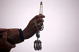 Images Dated 5th January 2018: A Kashmiri Muslim cleric displays a relic of Sufi saint Sheikh Abdul Qadir Jeelani at his